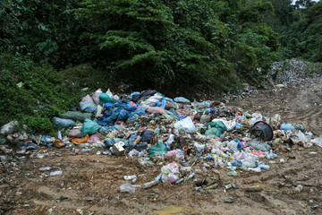 Garbage pile in trash dump or landfill. Plastic bags, plastic bottles and other waste dumped in...