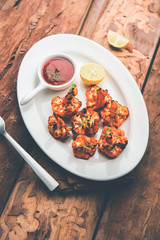 Tandoori Gobi / Roasted cauliflower Tikka is a dry dish made by roasting Cauliflowers in Oven/Tandoor. It's  popular starter food from India. served with ketchup. selective focus