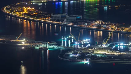 Foto op Plexiglas Aerial view of Palm Jumeirah Island night timelapse. © neiezhmakov
