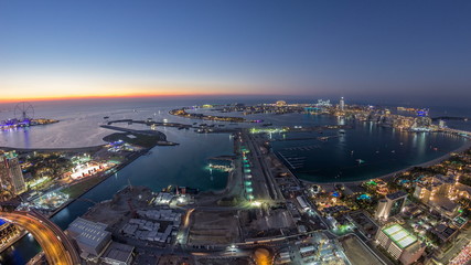 Aerial sunset view of Palm Jumeirah Island day to night timelapse.