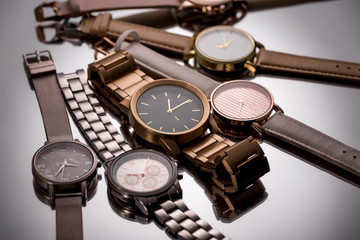 selective focus of luxury wristwatches on grey background - obrazy, fototapety, plakaty