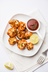 Tandoori Gobi / Roasted cauliflower Tikka is a dry dish made by roasting Cauliflowers in Oven/Tandoor. It's  popular starter food from India. served with ketchup. selective focus