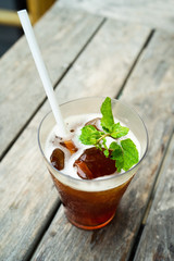 a glass of ice the with mint and white straw