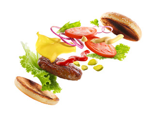 Delicious burger with floating ingredients, isolated on white background