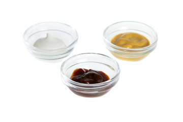 Bowls with sauces isolated on white background