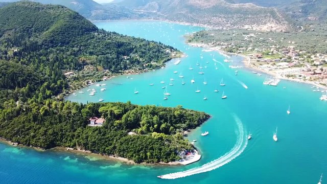 Aerial drone bird's eye view video of iconic port of Nidri or Nydri a safe harbor for sail boats and famous for trips to Meganisi, Skorpios and other Ionian islands, Lefkada island, Ionian, Greece