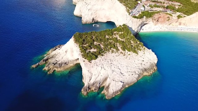 Aerial drone video of popular tropical paradise deep turquoise beach of Porto Katsiki with white steep rocky seascape and beautiful cloudy landscape, Lefkada island, Ionian, Greece