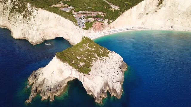 Aerial drone video of popular tropical paradise deep turquoise beach of Porto Katsiki with white steep rocky seascape and beautiful cloudy landscape, Lefkada island, Ionian, Greece