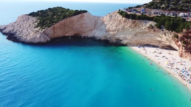 Aerial drone video of popular tropical paradise deep turquoise beach of Porto Katsiki with white steep rocky seascape and beautiful cloudy landscape, Lefkada island, Ionian, Greece