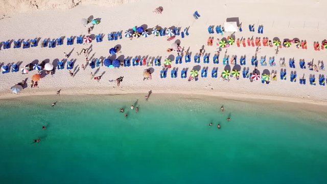 Aerial drone video of popular tropical paradise deep turquoise beach of Porto Katsiki with white steep rocky seascape and beautiful cloudy landscape, Lefkada island, Ionian, Greece