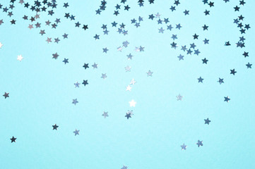 Silver glitter stars on blue background in vintage colors