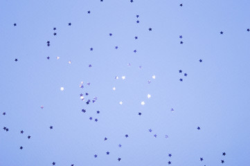 Silver glitter stars on blue background in vintage colors
