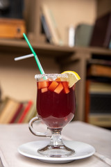 mulled wine in a glass with lemon and tubes