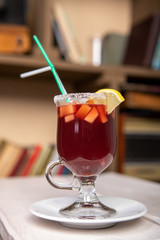 mulled wine in a glass with lemon and tubes