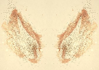 Golden glitter on abstract watercolor wings in vintage nostalgic colors.