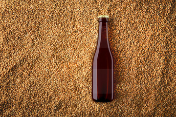 Brown beer glass bottlle mockup on wheat grains background with label.