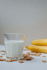 Glass of milk with bananas in the table