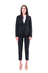 Obraz premium Confident businesswoman in black business suit standing with arms down looking up. Full body isolated on white background. 