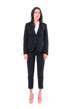 Successful Young Pretty Business Woman In Black Suit Standing With Arms Down Looking Away. Full Body Isolated On White Background. 