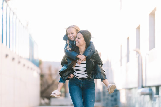 Woman doing young sister piggyback