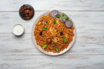 Homemade chicken Biryani. Arabic traditional food bowls Kabsa with meat. Top view. 
