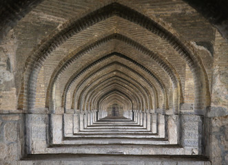 Arches of a beautiful historic Khan  bridge over Zayandeh River in Isfahan, Iran (also known as Khaju, Si-o-seh pol)