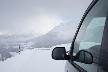Van driving along a snowcapped mountain road