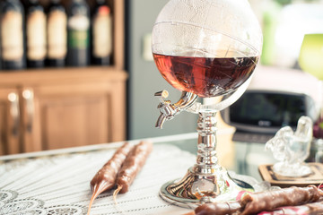 Glass carafe in the form of the globe with brandy on the counter of liquor store.