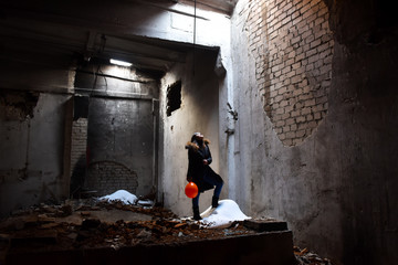 girl with a balloon in an abandoned building