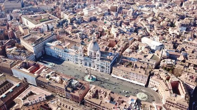 Aerial drone video of iconic landmark Piazza Navona (Square) featuring Fountain of the Four Rivers with an Egyptian obelisk and Sant Agnese Church in the heart of Rome, Italy