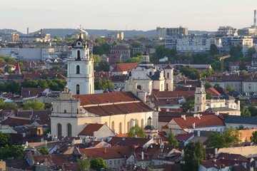 Obraz premium Cityscape Vilnius panorama top view on the old town with churches and rooftops. Vilnius Old Town was included in the UNESCO World Heritage List.