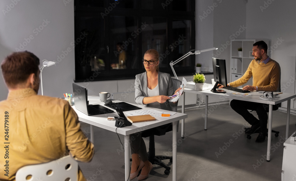 Wall mural business, deadline and technology concept - software developers discussing user interface design moc