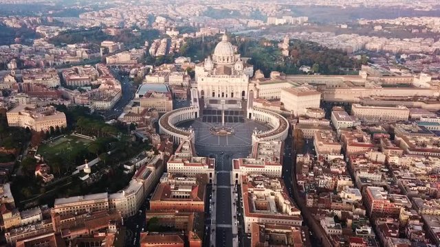 Aerial drone video of Saint Peter's square in front of world's largest church - Papal Basilica of St. Peter's, Vatican - an elliptical esplanade created in the mid seventeenth century, Rome, Italy
