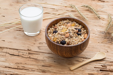Mixed Muesli with a glass of Milk on wooden background