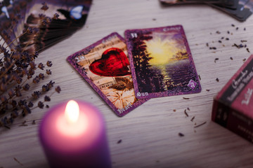 vintage divination cards with lavender and burning candle