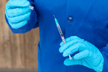 Hand of doctor holds syringe with medicine. Concept diseases, euthanasia, medical care, science, diabetes.