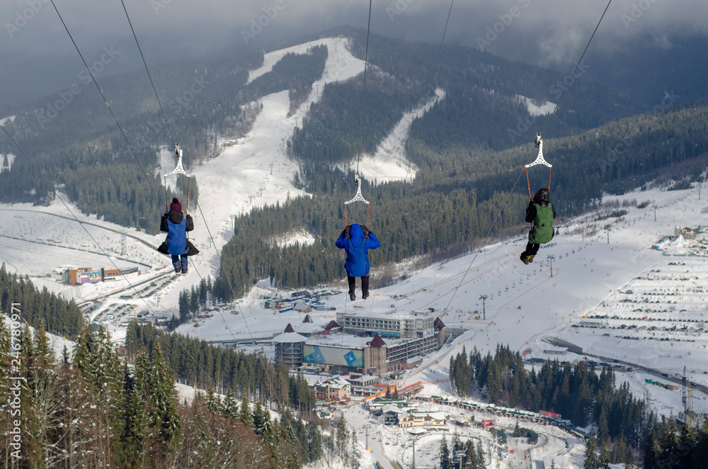 Wall mural zip-line in the mountains winter three people