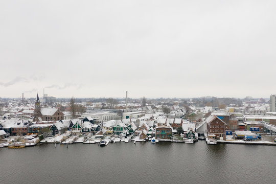 View of the town of Zaandijk, just outside of Amsterdam at the river De Zaan. The houses and streets are covered in snow.