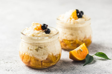 Coconut milk rice pudding with citrus jam. Selective focus, space for text.