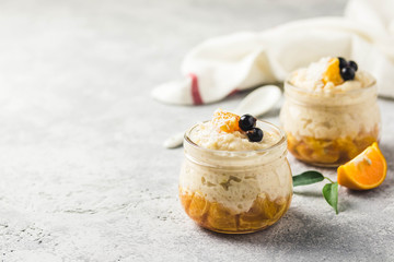 Coconut milk rice pudding with citrus jam. Selective focus, space for text.
