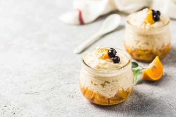Creamy vanilla rice pudding with citrus jelly and berries. Selective focus, space for text.