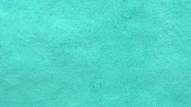 background of turquoise handmade Huun paper created by Mayan artisans in Mexico from a tree bark - horizontal pan