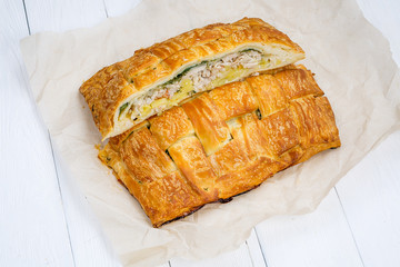 Tasty pie is divided into half, stuffing, potato and pieces of chicken.