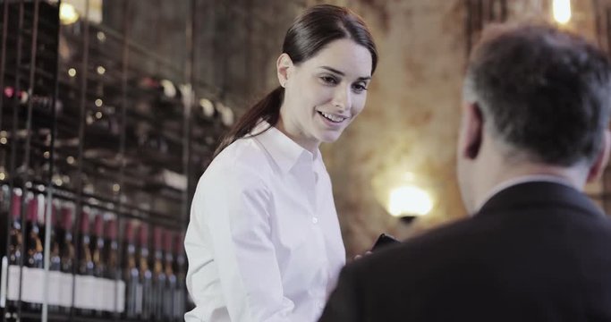 Waitress taking food order on digital device in restaurant