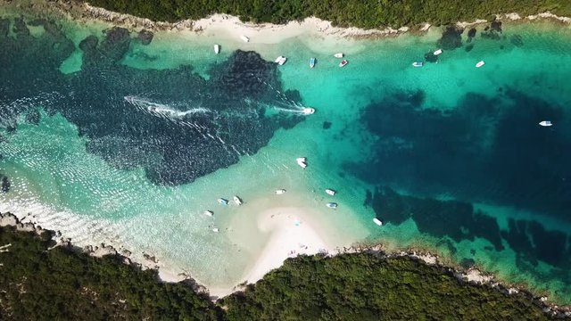 Aerial bird's eye view video taken by drone of boat in tropical paradise seascape  
