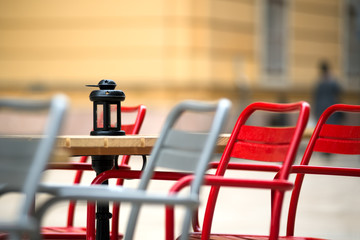 Side cafe environment. Chairs and Lamp on a table outdoors