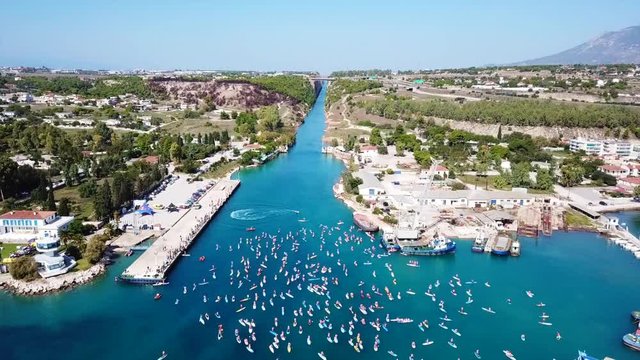 Aerial bird's eye view video taken by drone of stand up paddle surfing competition or SUP in Corinth Canal of Isthmos, Peloponnese, Greece