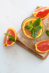 glasses with a refreshing drink with orange and mint leaves on a white background top view.