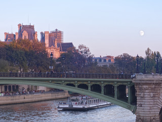 Moon over the Seine river and Paris cityhall - Paris, France