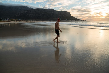 Senior man preparing to swim in the sea at dawn